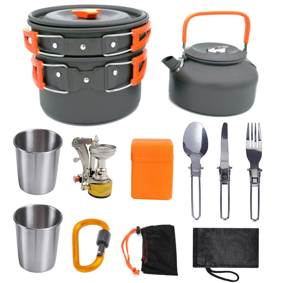 Collection of camping cookware and utensils including pots, kettle, cups, and cutlery on a white background.