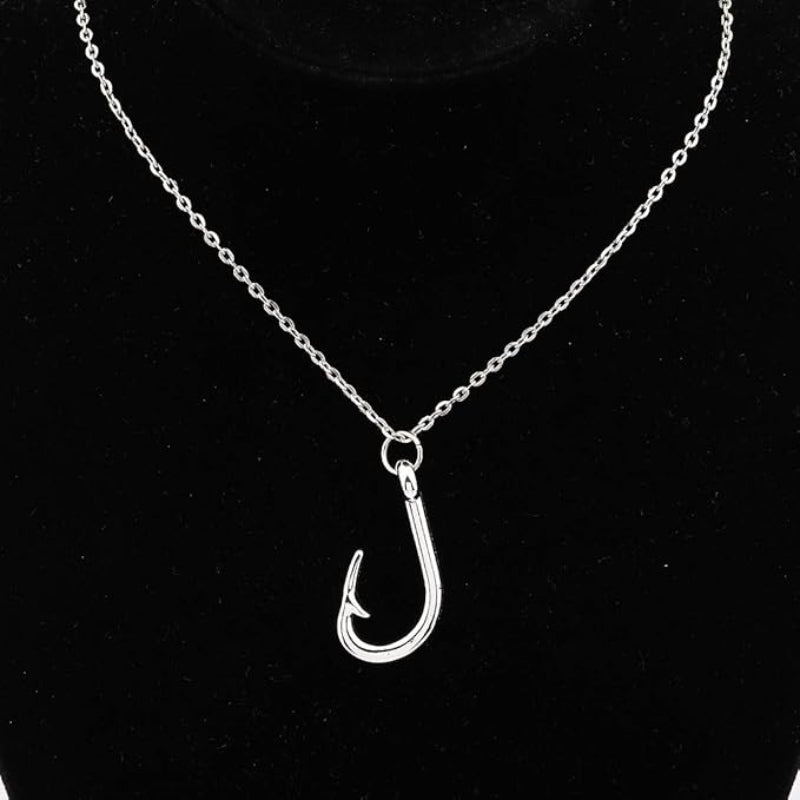 Silver fish hook pendant on a chain against a black background