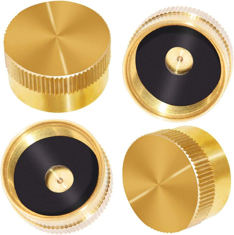 Four gold metal knobs on a white background