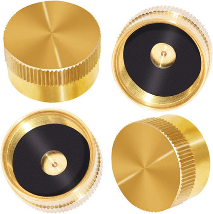 Four gold metal knobs on a white background