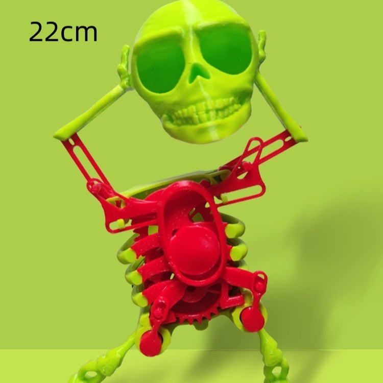 Toy skeleton with green skull and red body on a green background