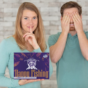 Two people with a 'Handu Fishing' product box in the foreground
