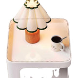 Small table with a lamp and a cup of coffee on a white background