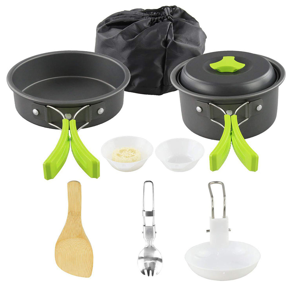 Set of camping cookware with pots, pans, and utensils on a white background