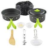 Set of camping cookware with pots, pans, and utensils on a white background