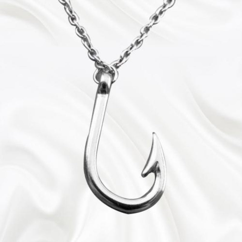 Silver fishing hook pendant on a chain against a white background
